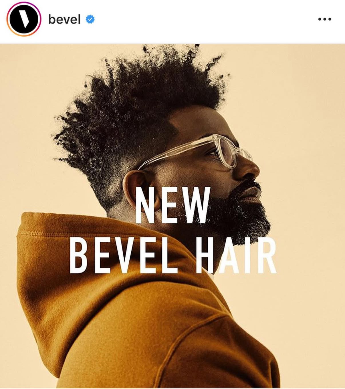 New Bevel Hair campaign portrait featuring clear glasses and a brown hoodie