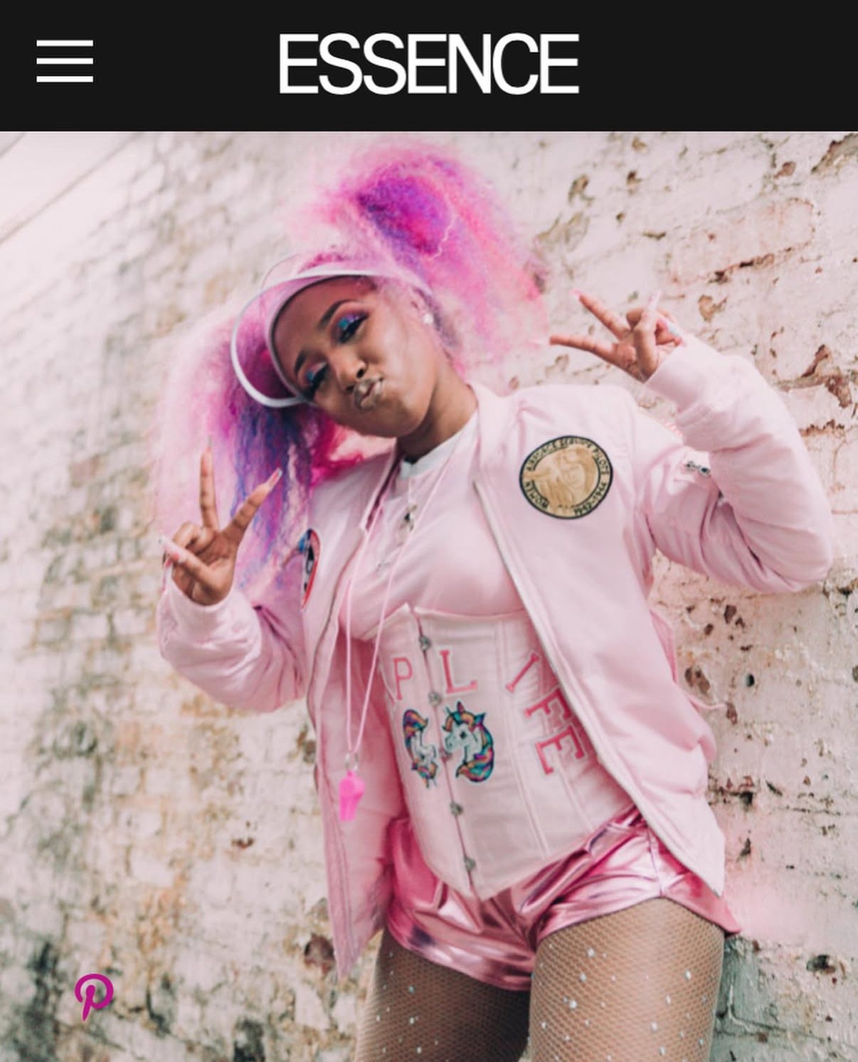 ESSENCE fashion photograph of Yung Baby Tate in a full-length pink look