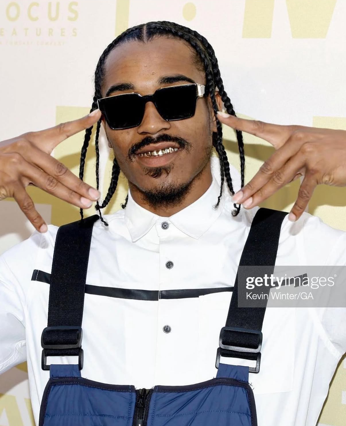 Mike Dyl in a blue overall look on the Honk for Jesus, Save Your Soul premiere red carpet, photographed by Kevin Winter/GA for Getty Images